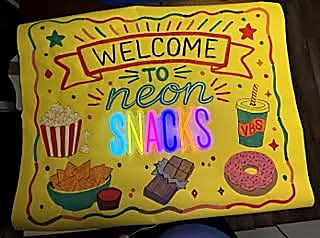 Bright hand-painted Neon Snacks event banner for a church or community event